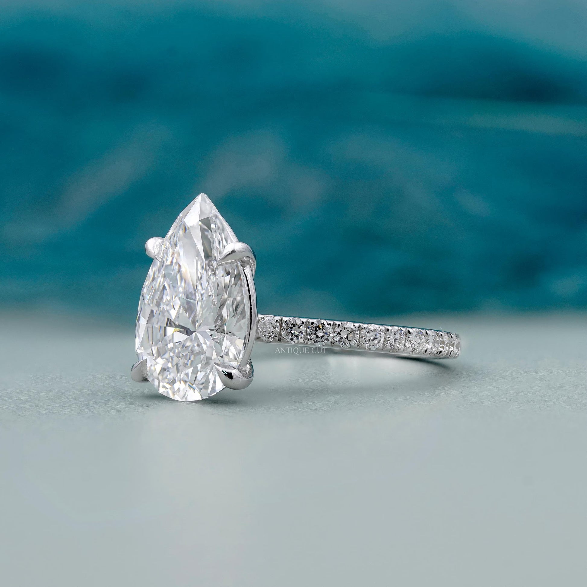 IGI certified pear diamond ring with round side stones