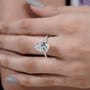 Classic pear engagement ring with round side stones