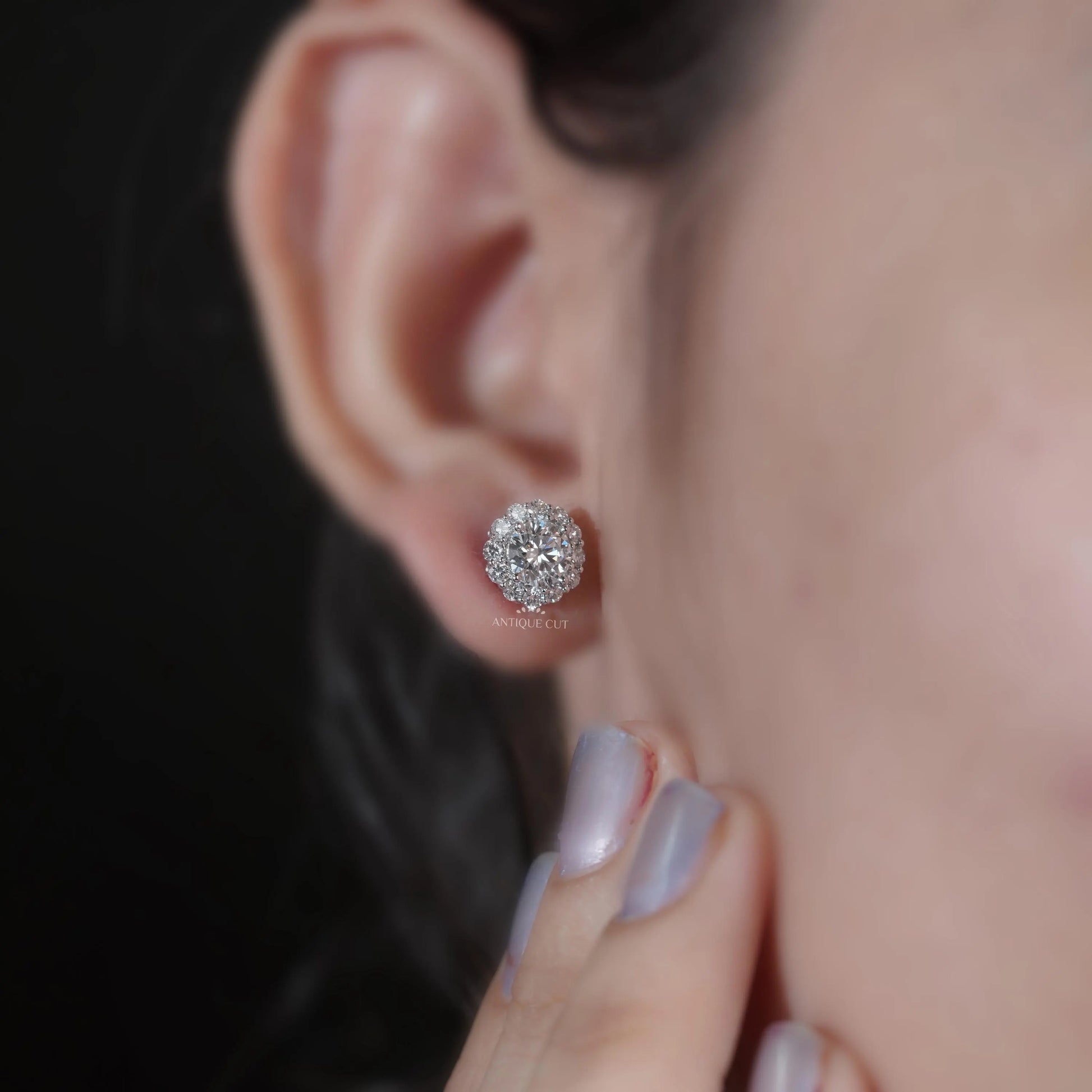 White gold diamond earrings with round solitaire center