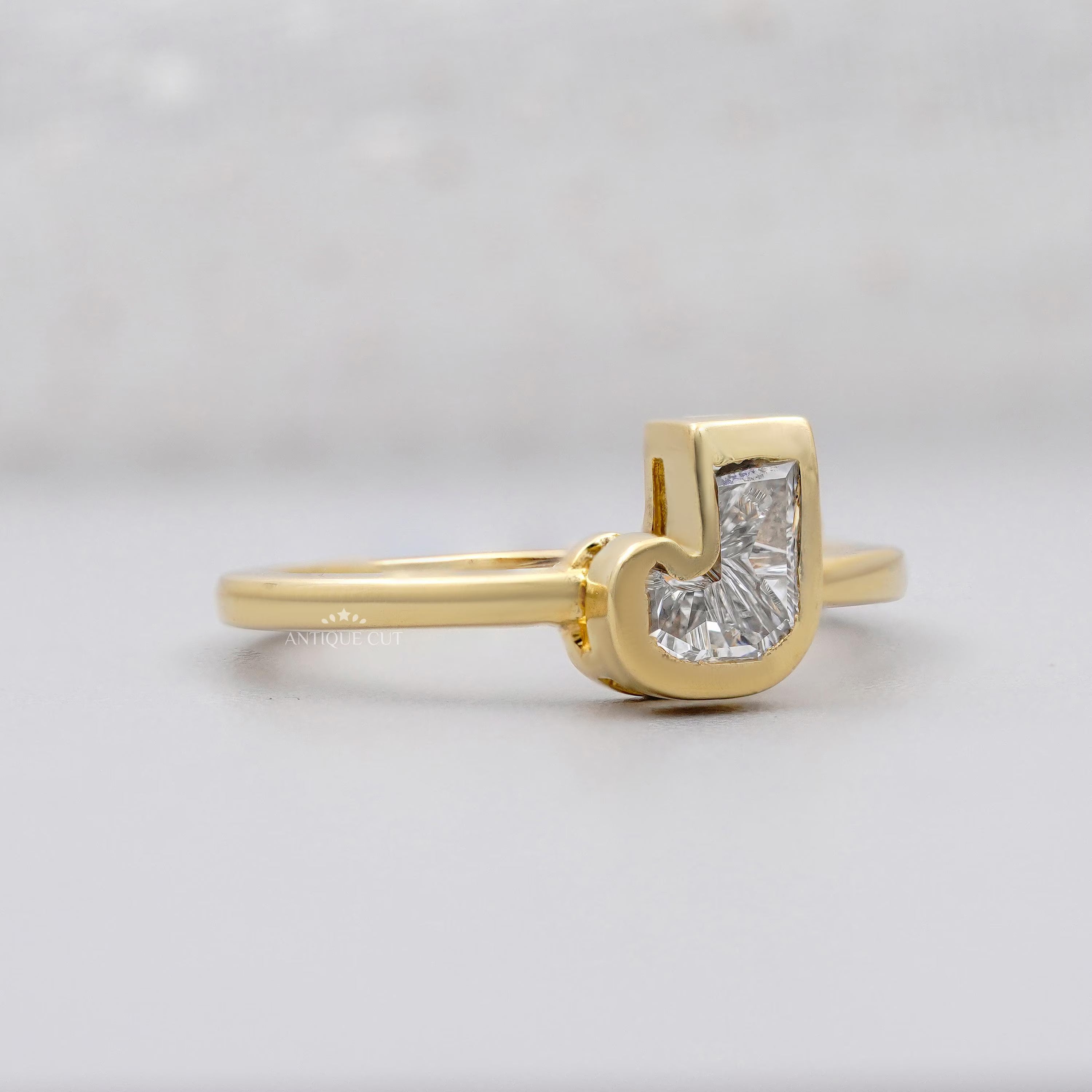 Yellow gold J initial diamond bezel set ring