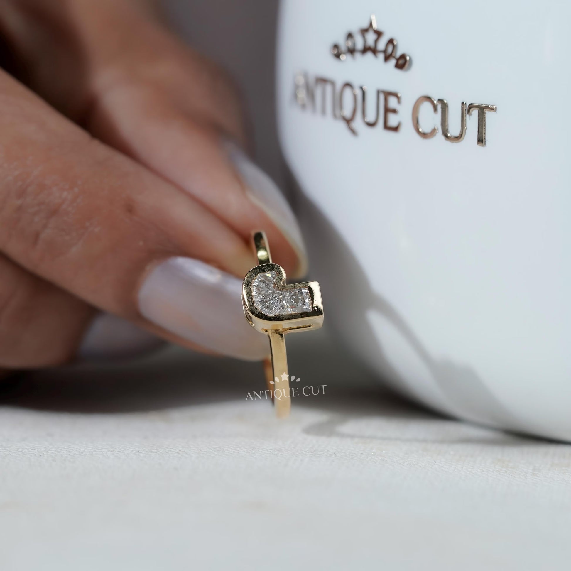 Yellow gold J shape ring top view