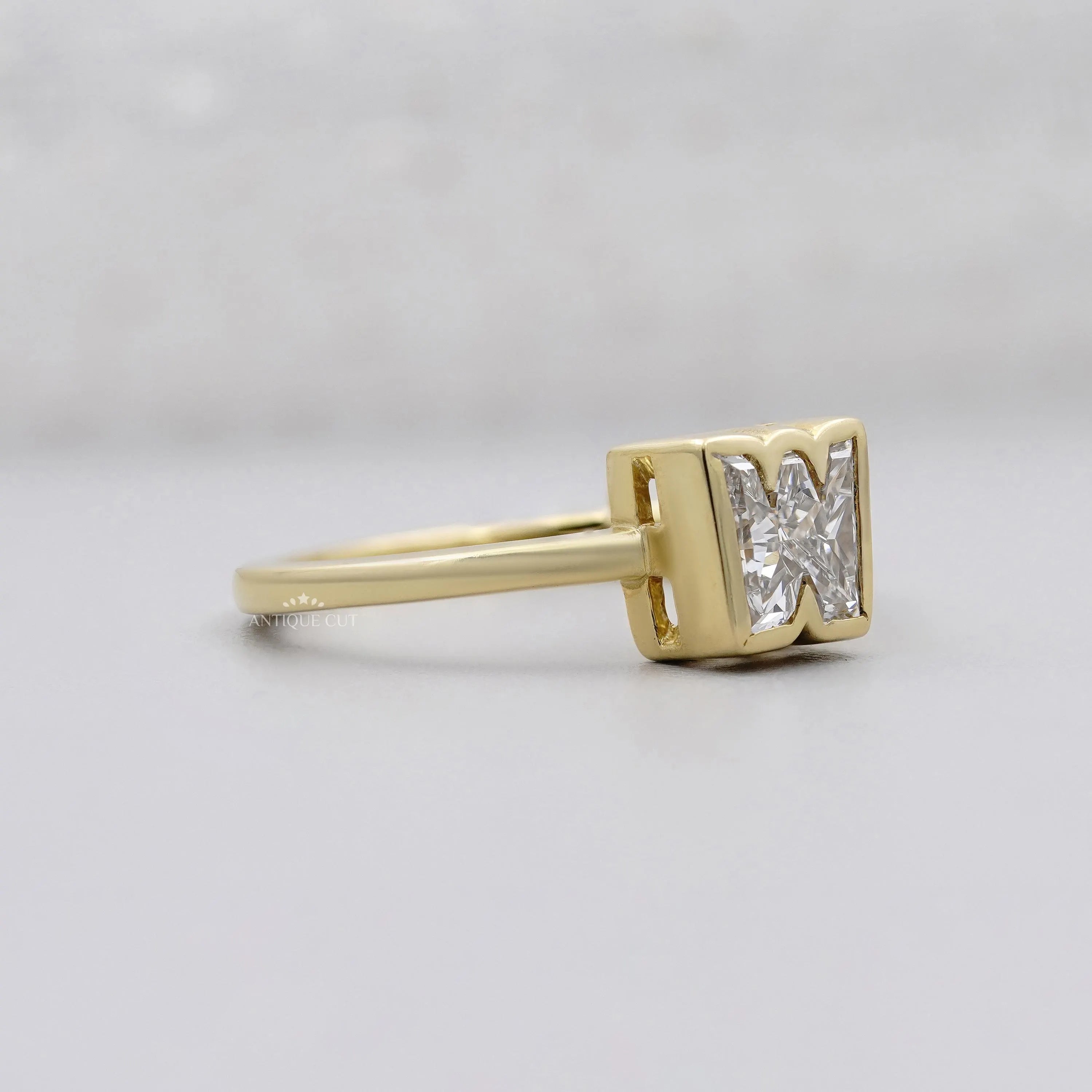W initial diamond ring with solitaire setting in yellow gold