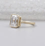 Bezel set emerald engagement ring close-up