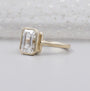 Yellow gold emerald diamond engagement ring with bezel setting