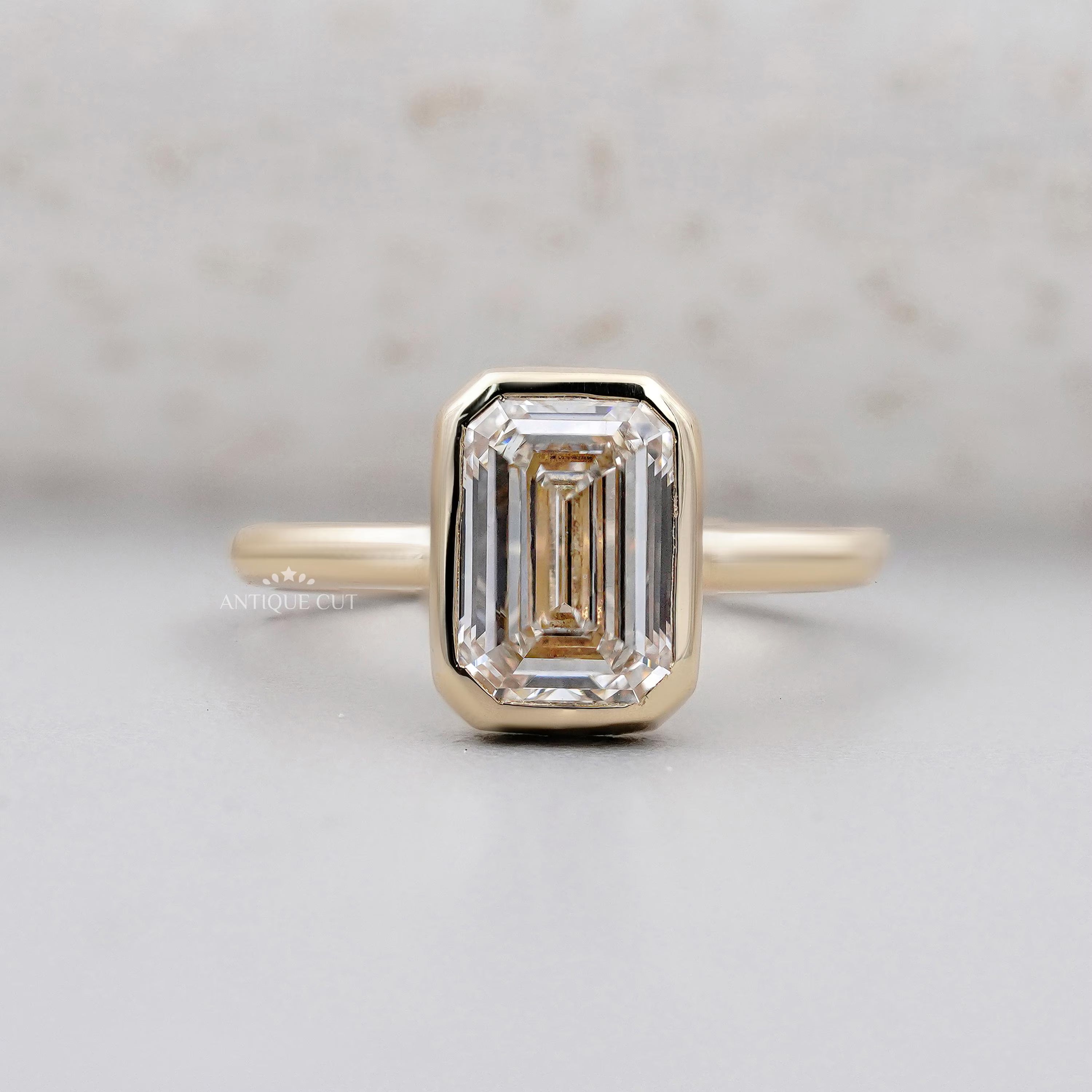 Emerald cut solitaire engagement ring in yellow gold