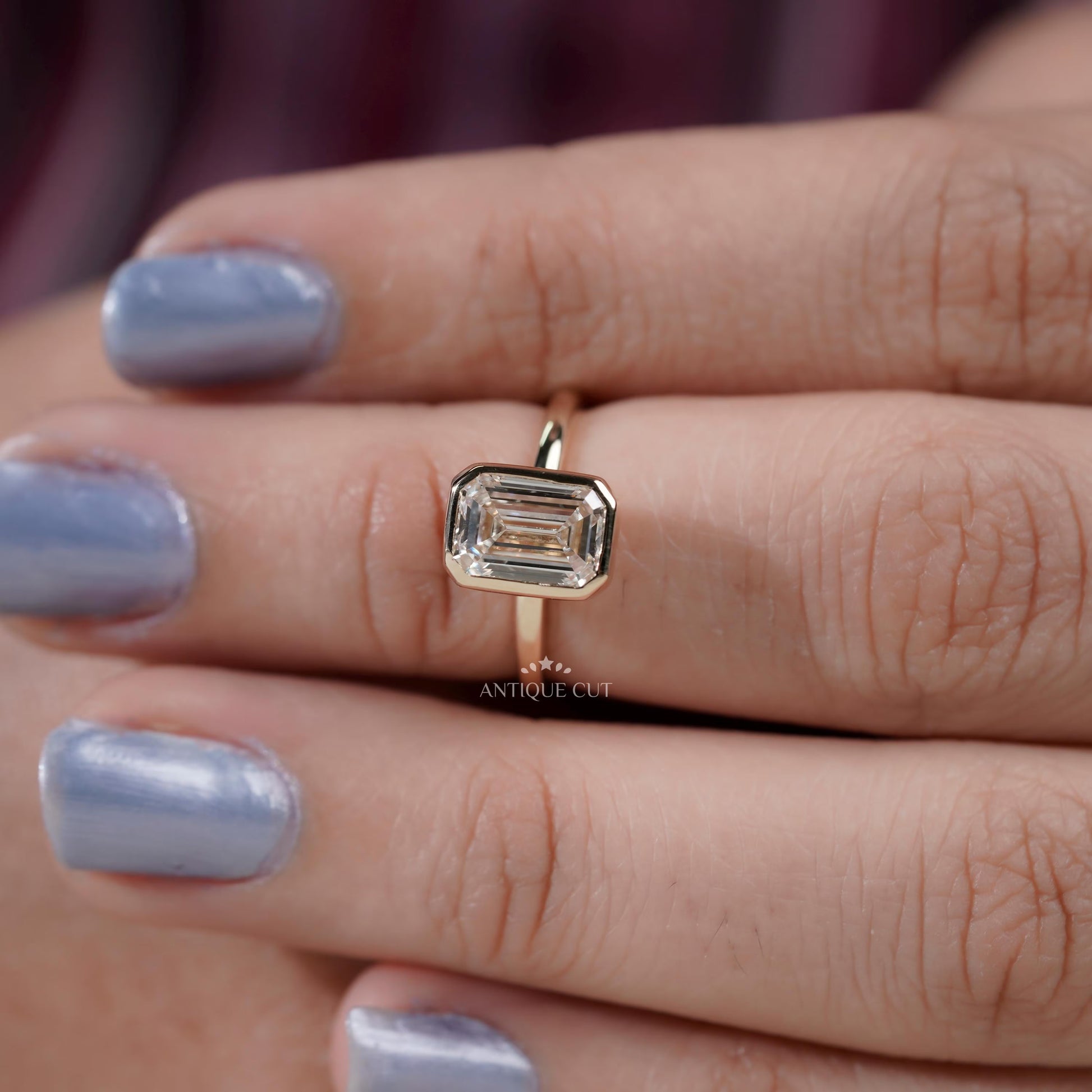 Emerald diamond ring side view bezel setting