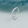 Emerald solitaire engagement ring with diamond pave band