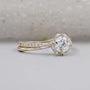 Round diamond engagement ring with floral halo and twisted band
