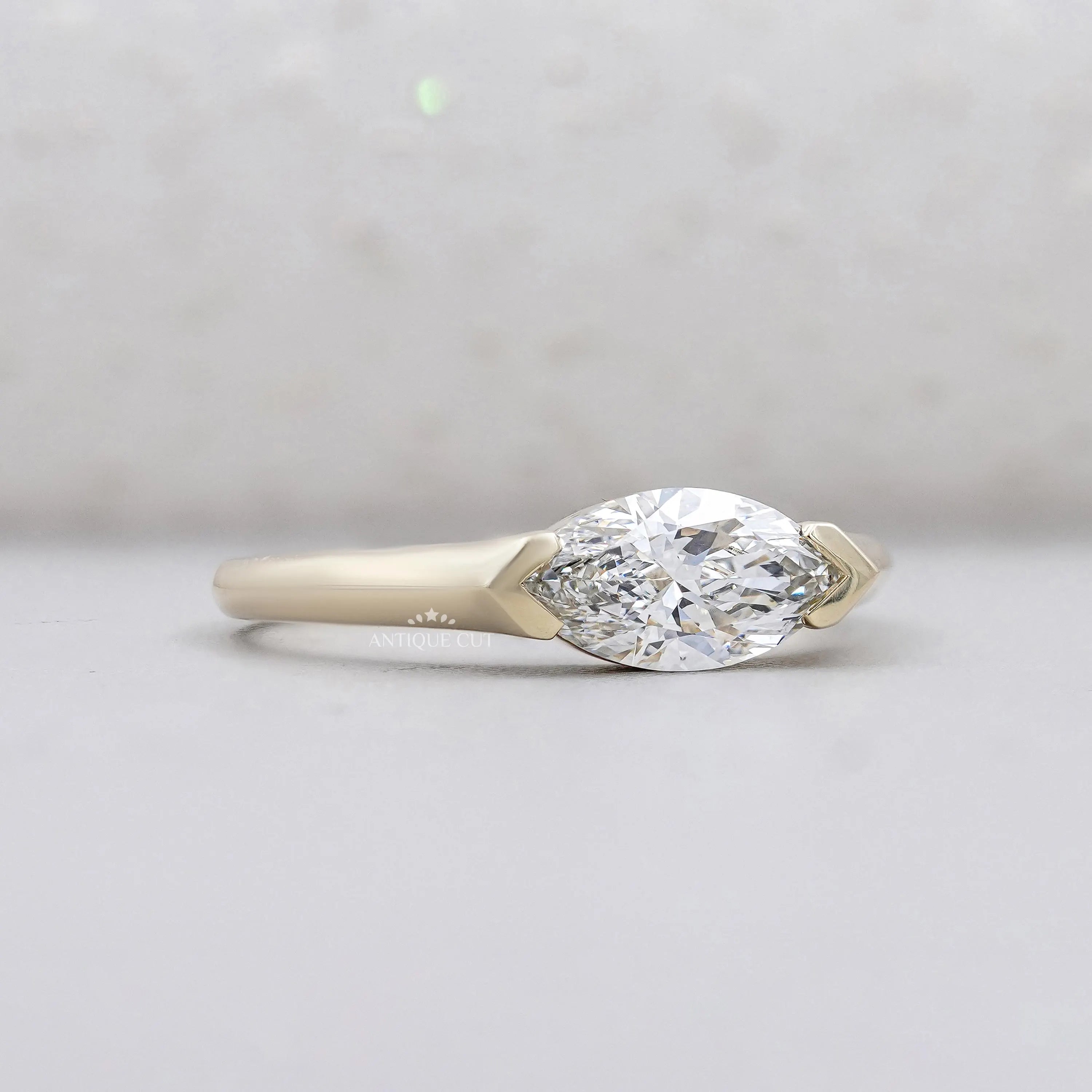 East West marquise cut diamond solitaire engagement ring