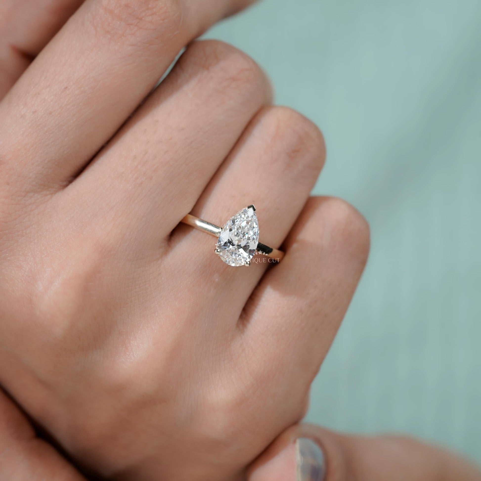 Yellow gold pear solitaire diamond ring