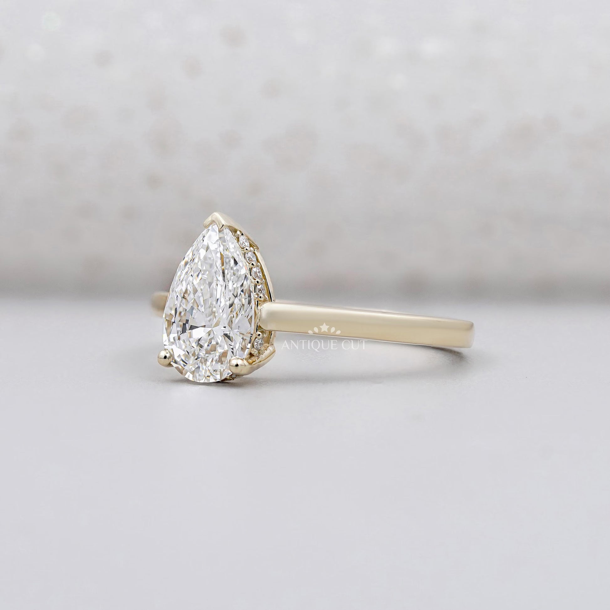 Solitaire diamond pear ring with hidden halo