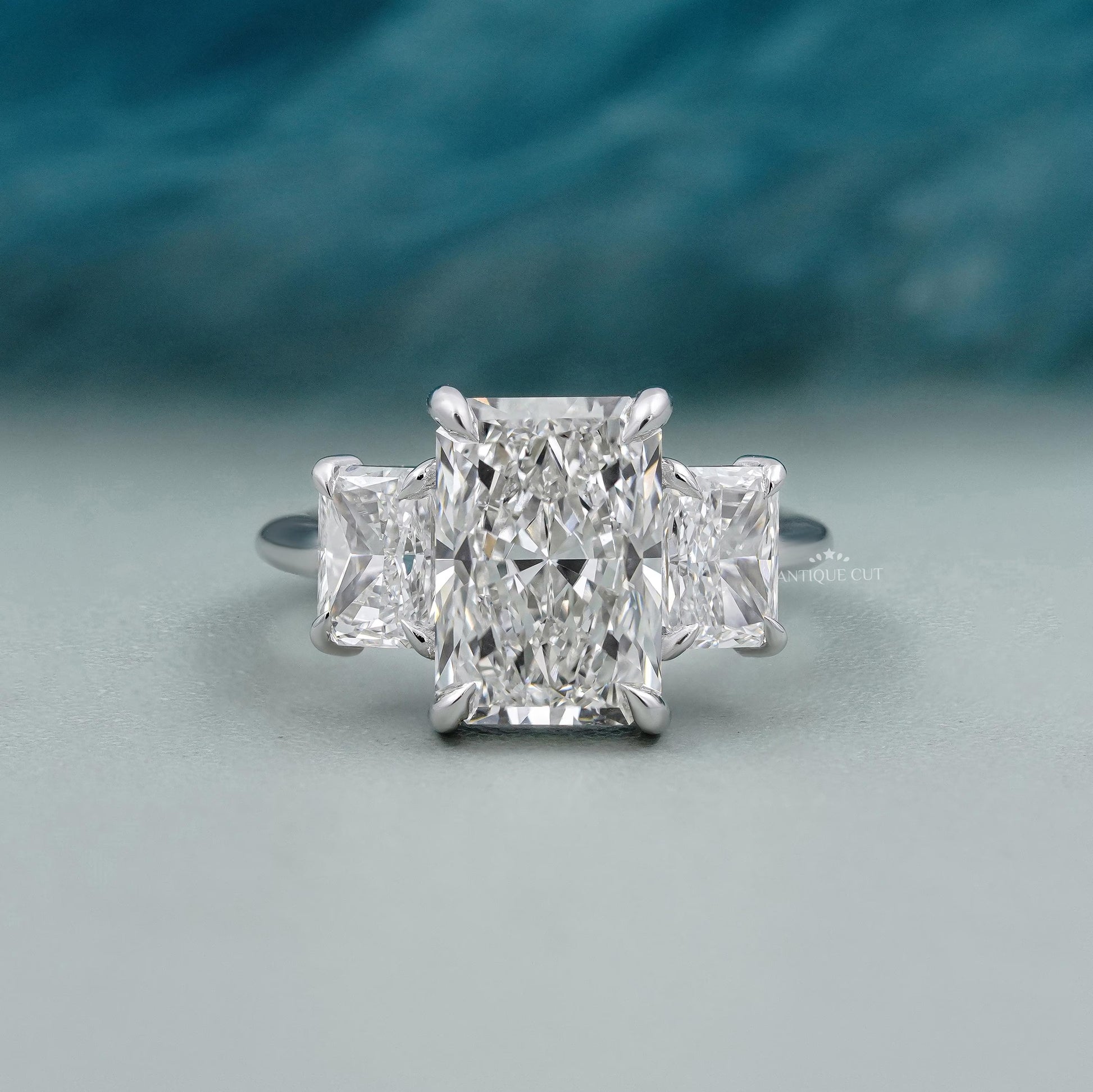 Radiant cut diamond three stone engagement ring