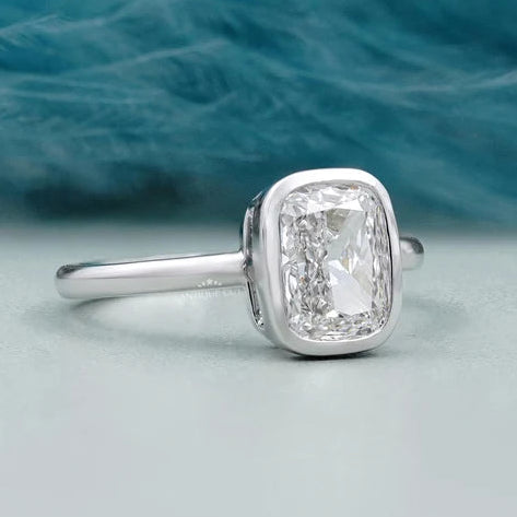 Solitaire cushion diamond ring in polished white gold