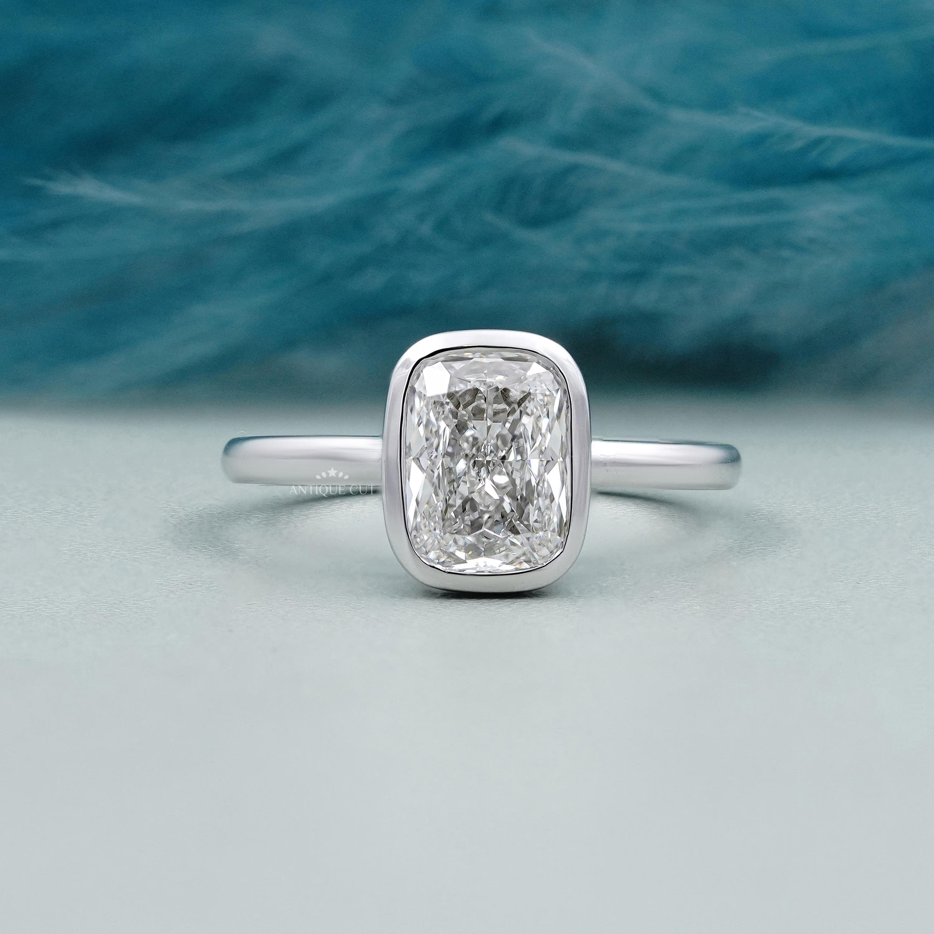 Cushion cut engagement ring bezel set in white gold