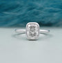 Cushion cut engagement ring bezel set in white gold