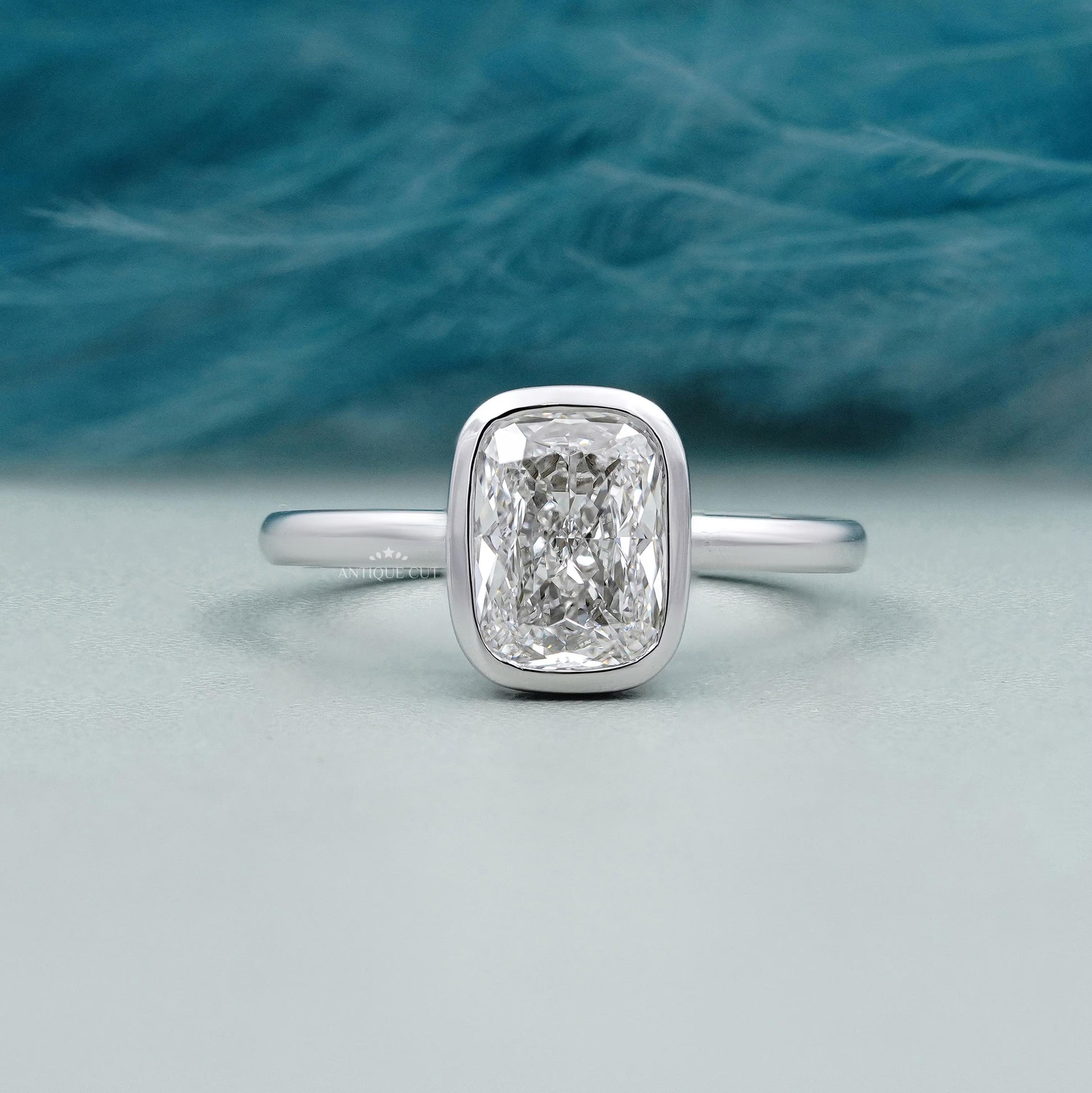 Cushion cut engagement ring bezel set in white gold
