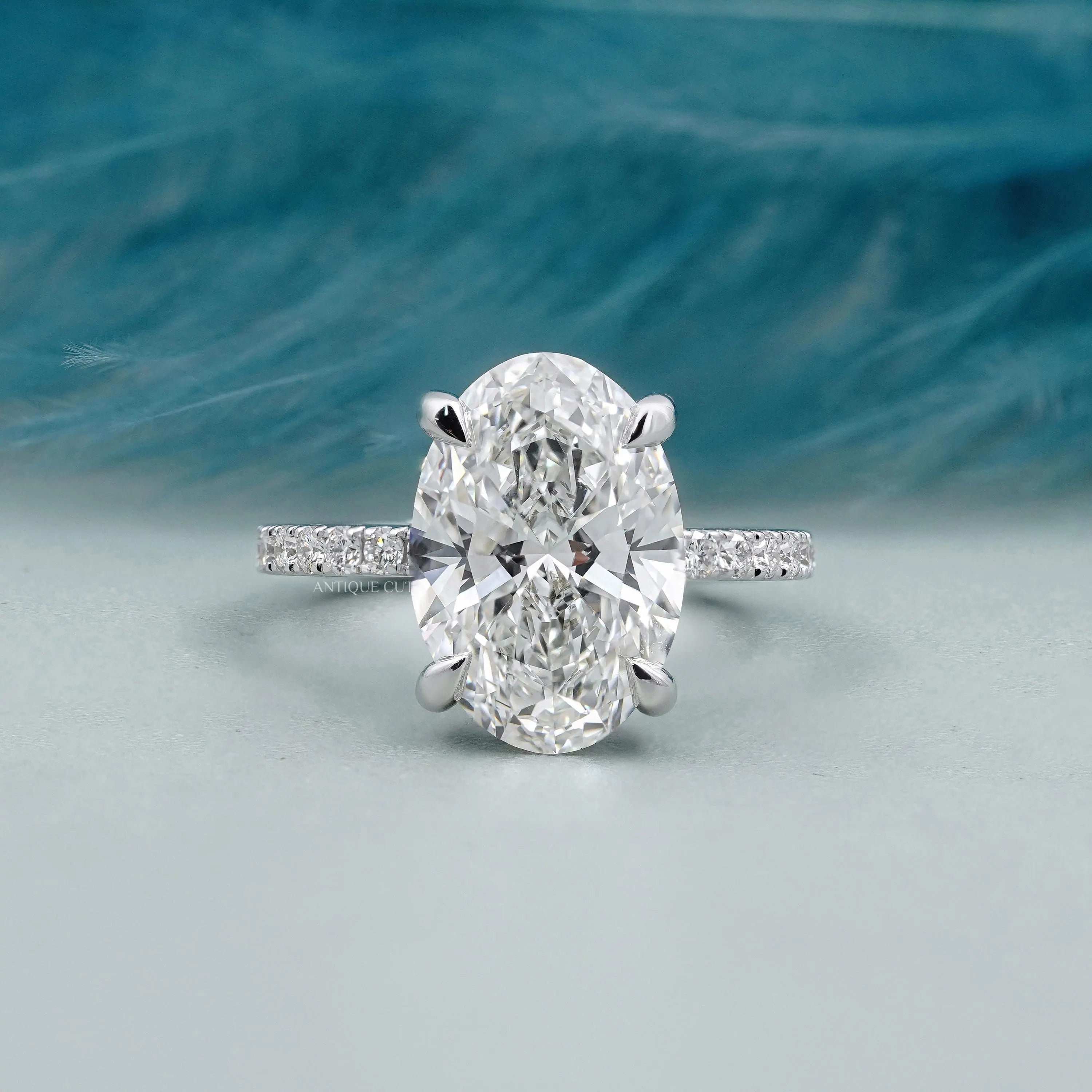 Oval solitaire engagement ring with pave band