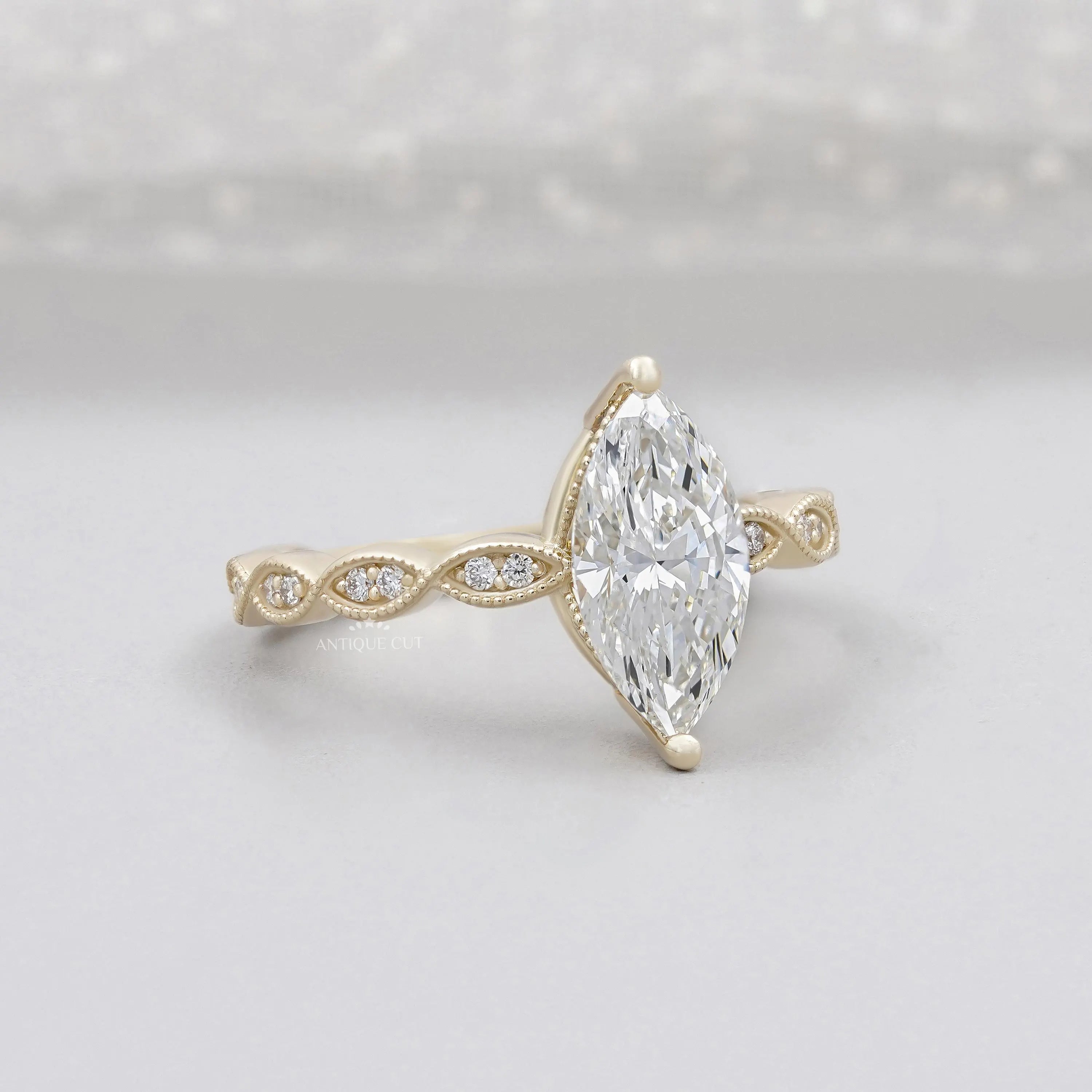 Marquise cut diamond engagement ring with vintage inspired band