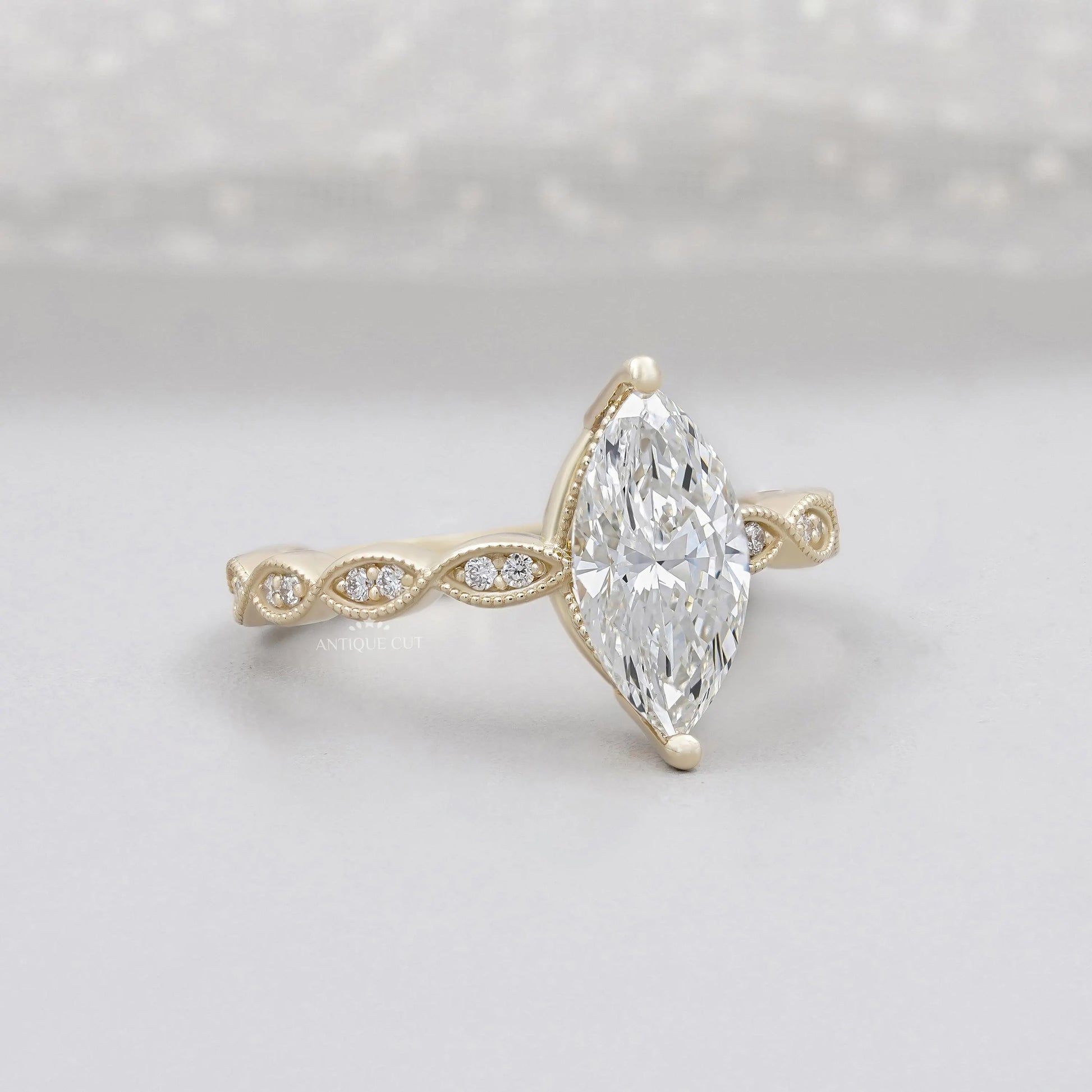 Marquise cut diamond engagement ring with vintage inspired band
