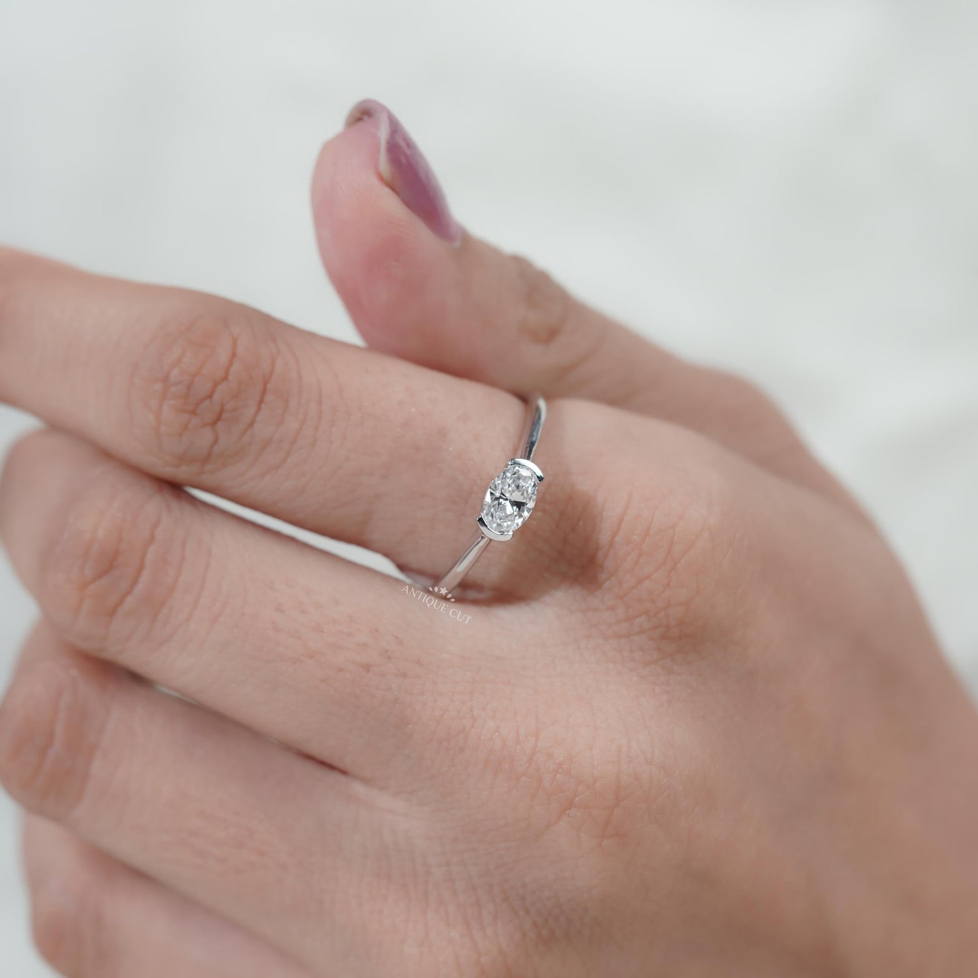 Classic oval diamond ring with unique East West setting