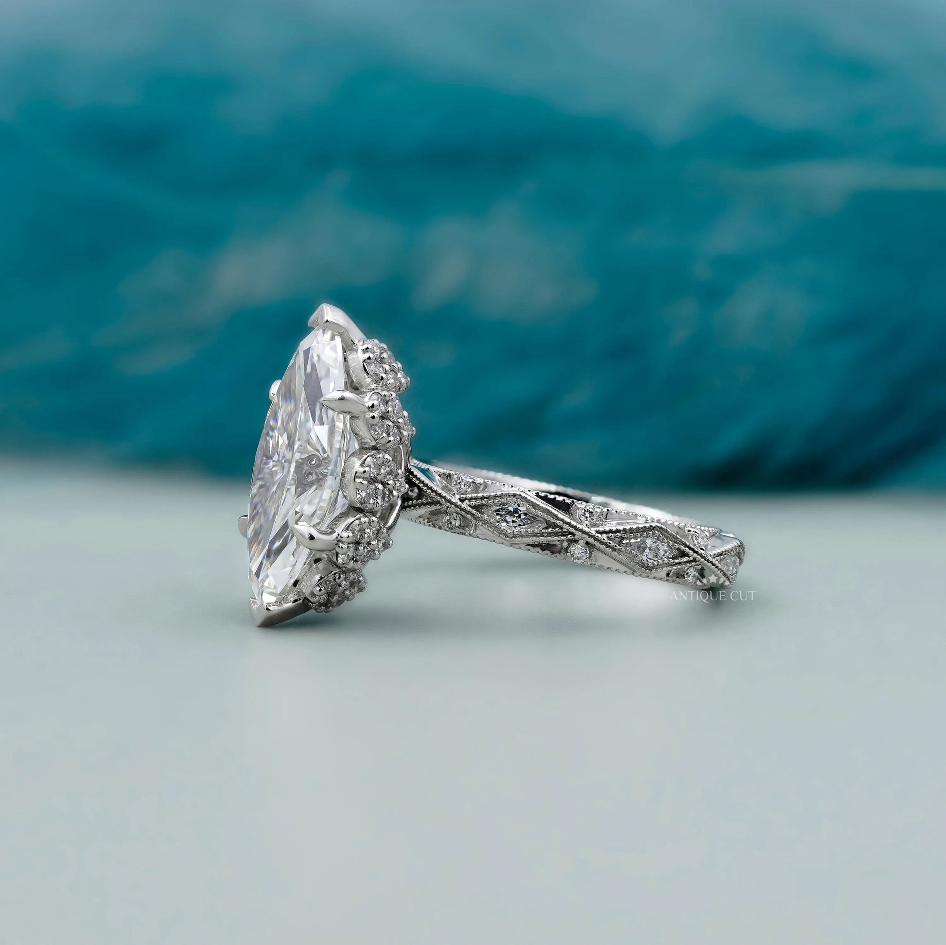 Marquise diamond ring with hidden halo round diamonds