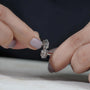 Round solitaire diamond earrings with surrounding halo stones