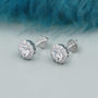 Round diamond halo stud earrings with solitaire center stone