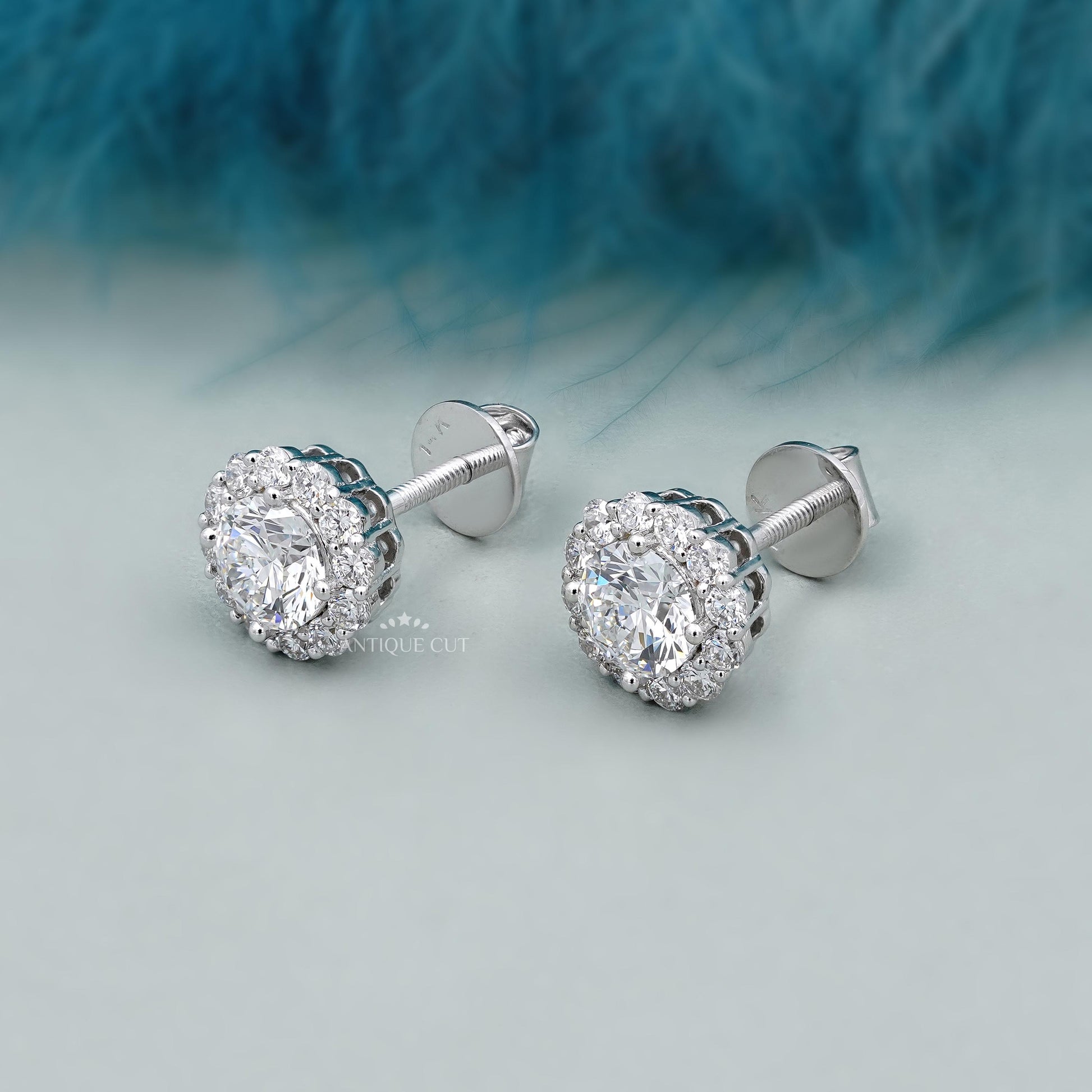 Round diamond halo stud earrings with solitaire center stone