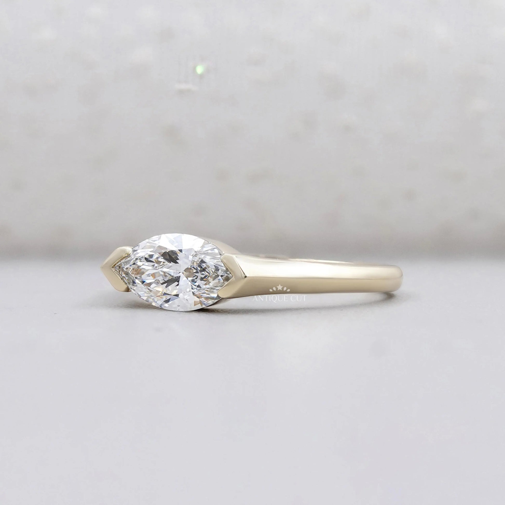 Horizontal marquise diamond engagement ring in yellow gold