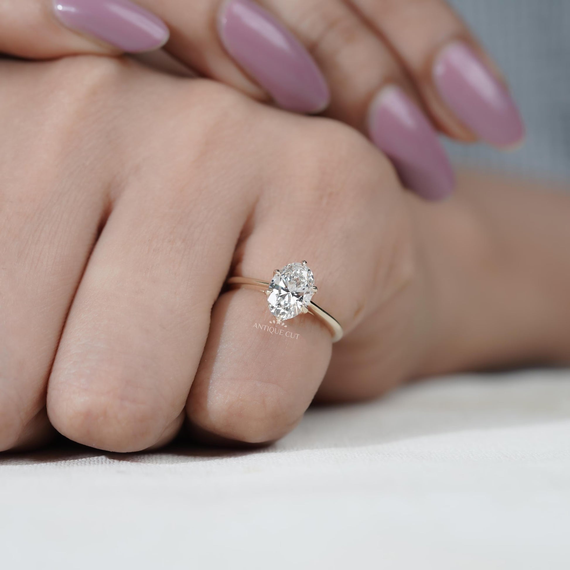 Modern six prong oval cut diamond ring