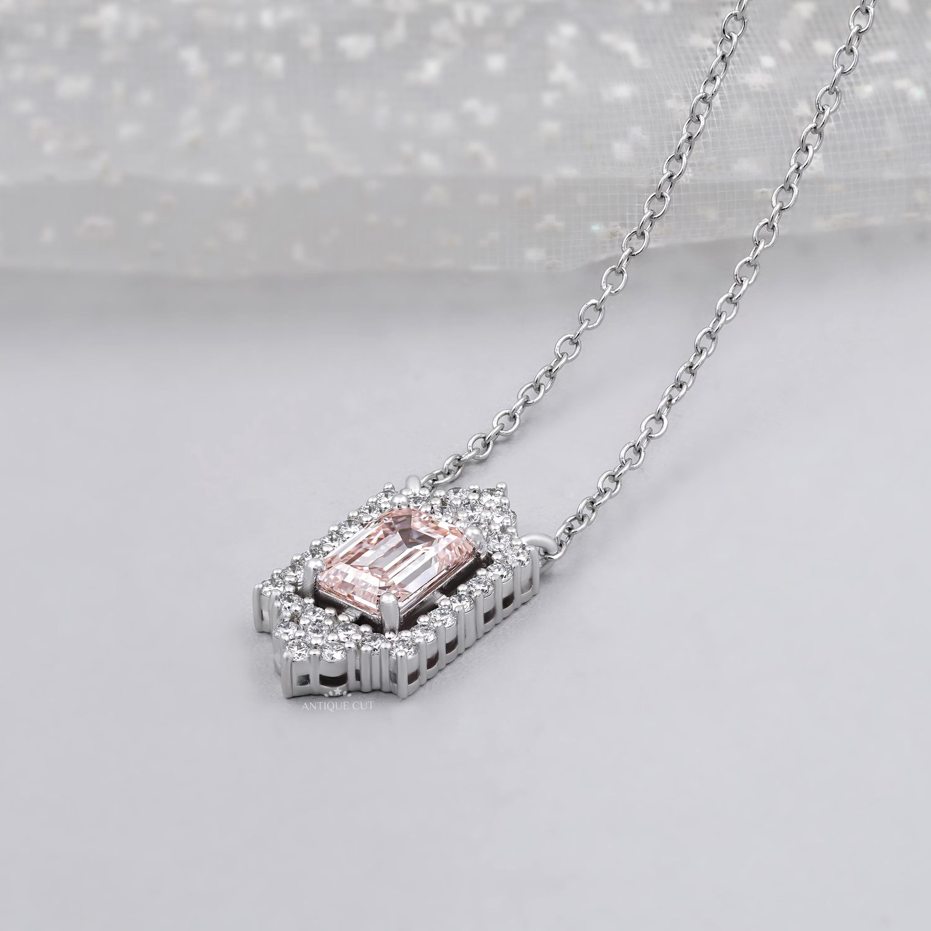 Blush pink emerald with round diamond halo pendant white gold