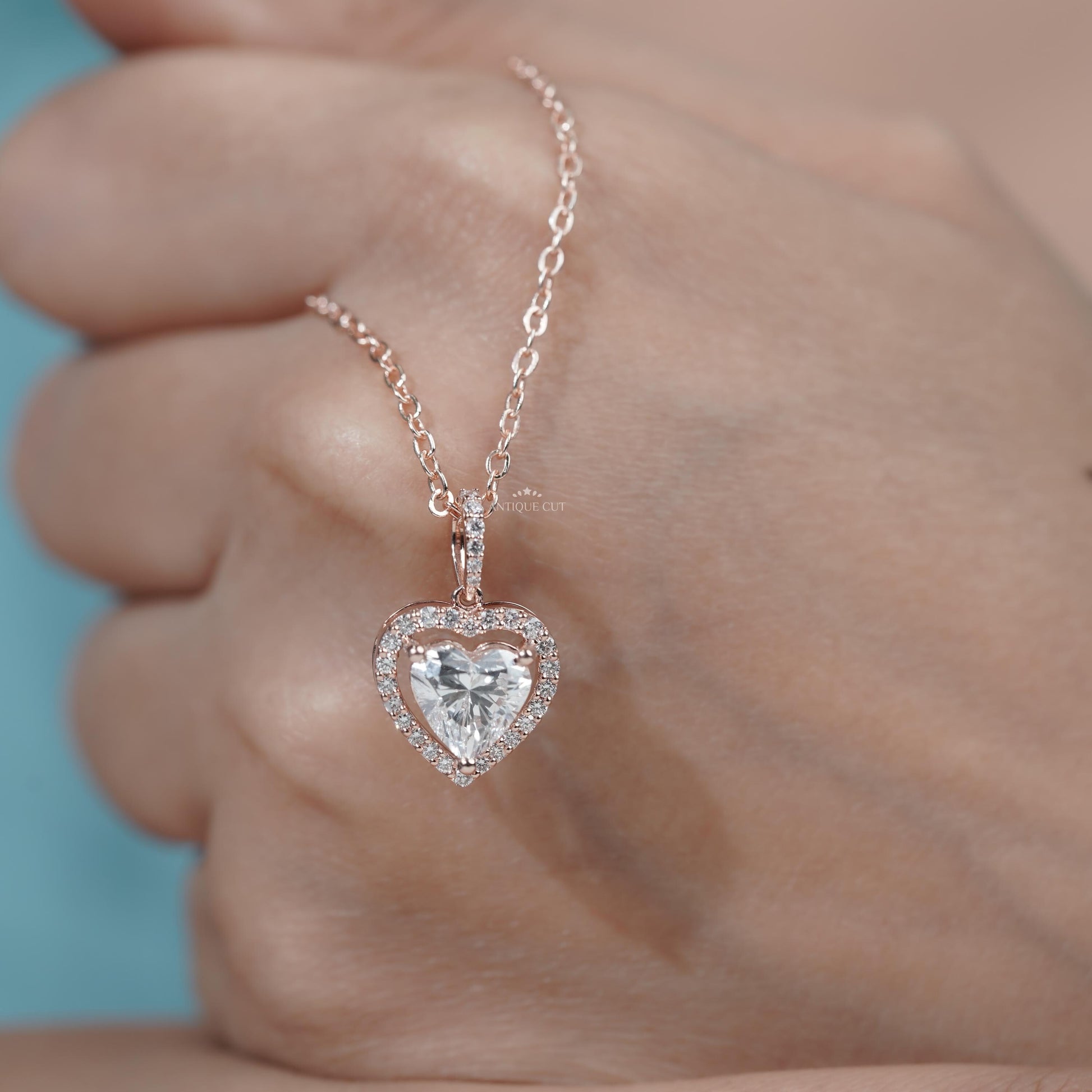 Rose gold halo diamond pendant with heart center