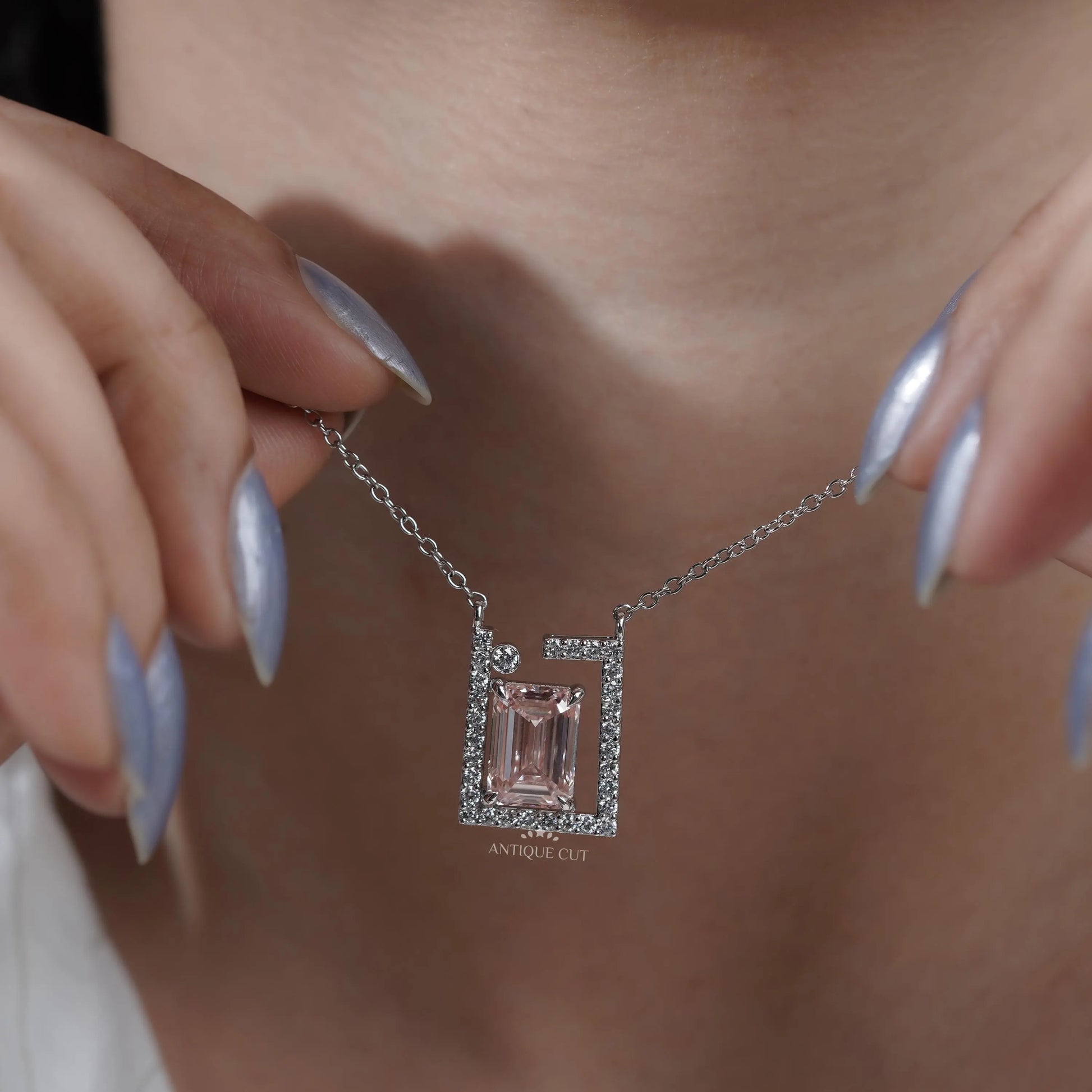 Modern frame diamond pendant with emerald center