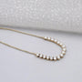 Yellow gold round diamond curved necklace