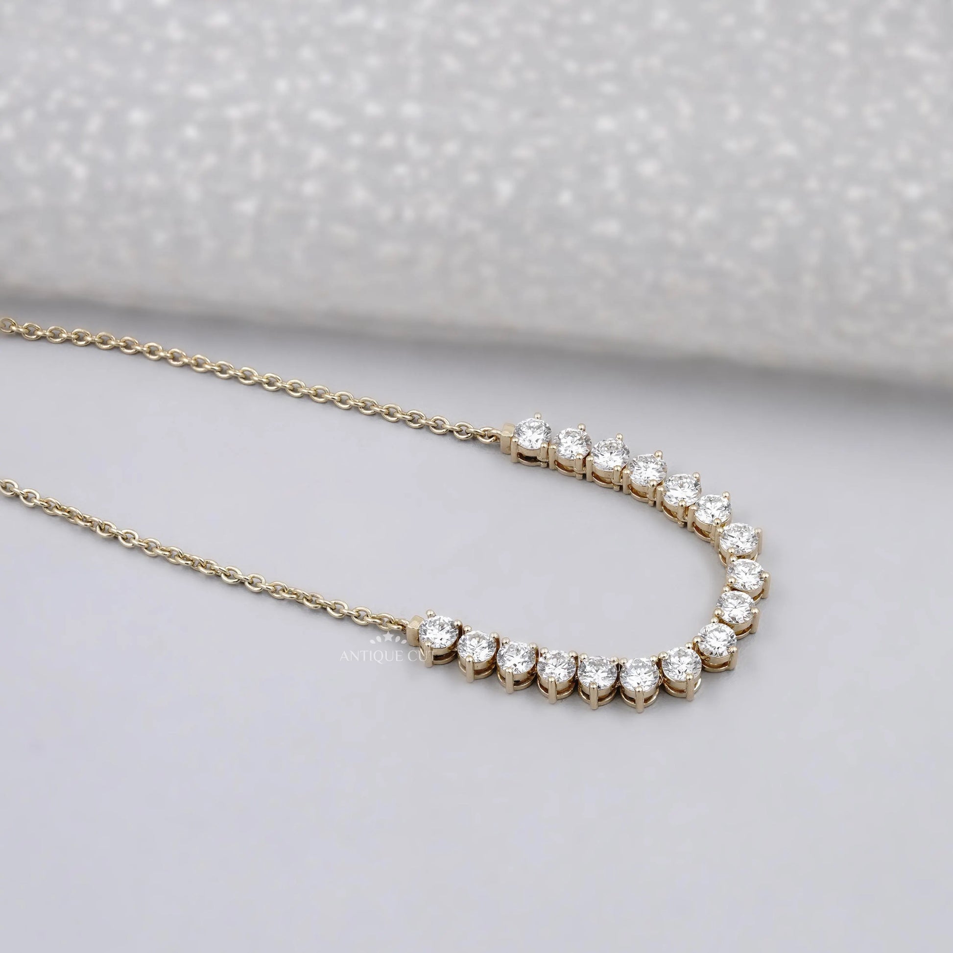 Yellow gold round diamond curved necklace