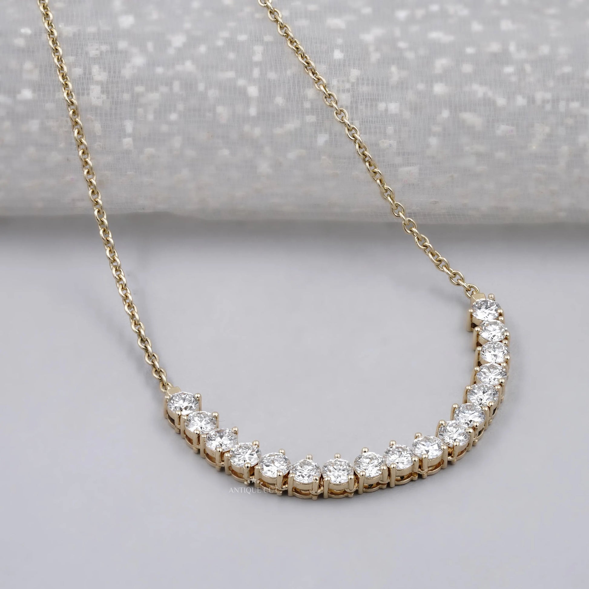 Yellow gold curved bar pendant with round diamonds