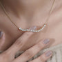 Round diamond pendant with curved bar style