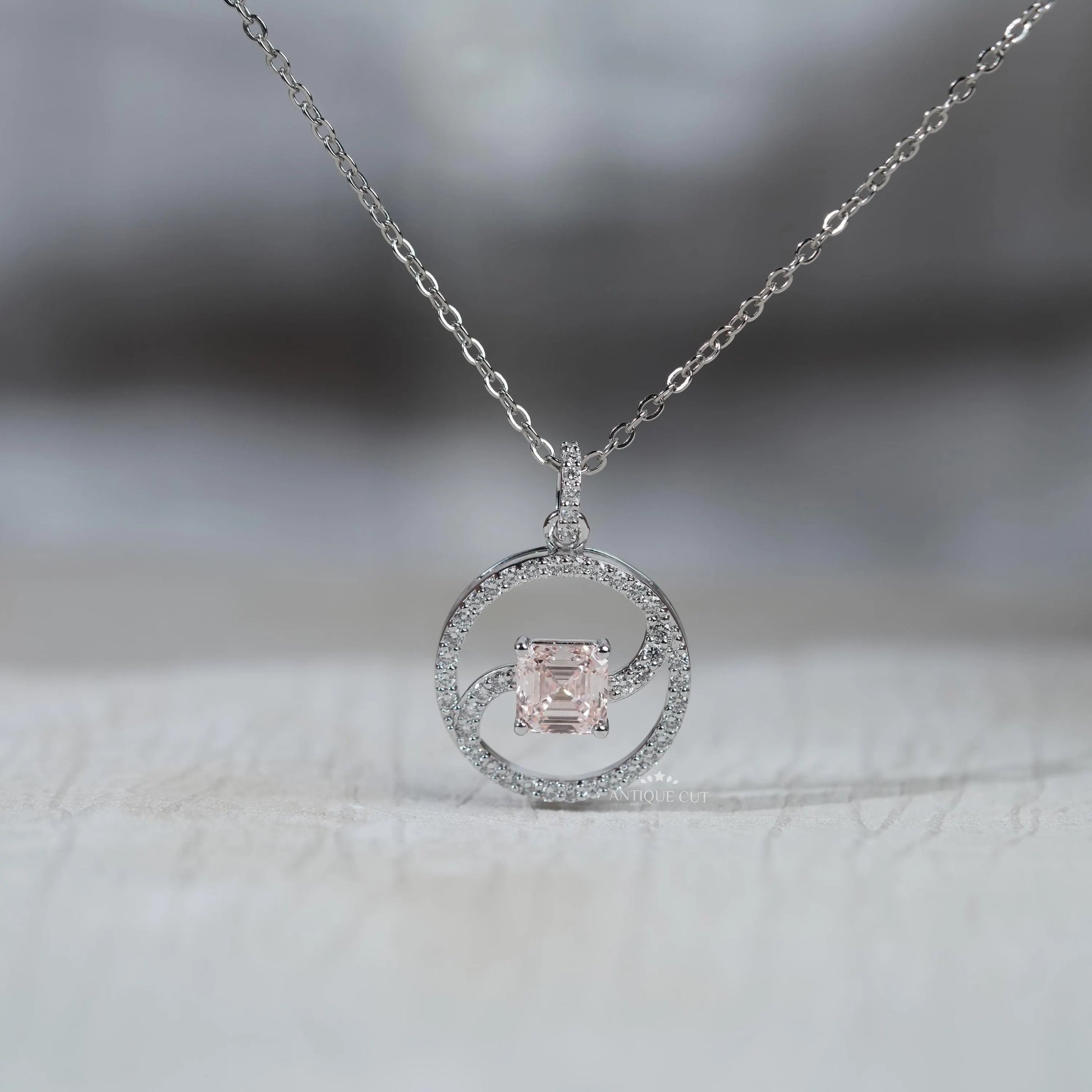 White gold swirl circle pendant with Asscher diamond