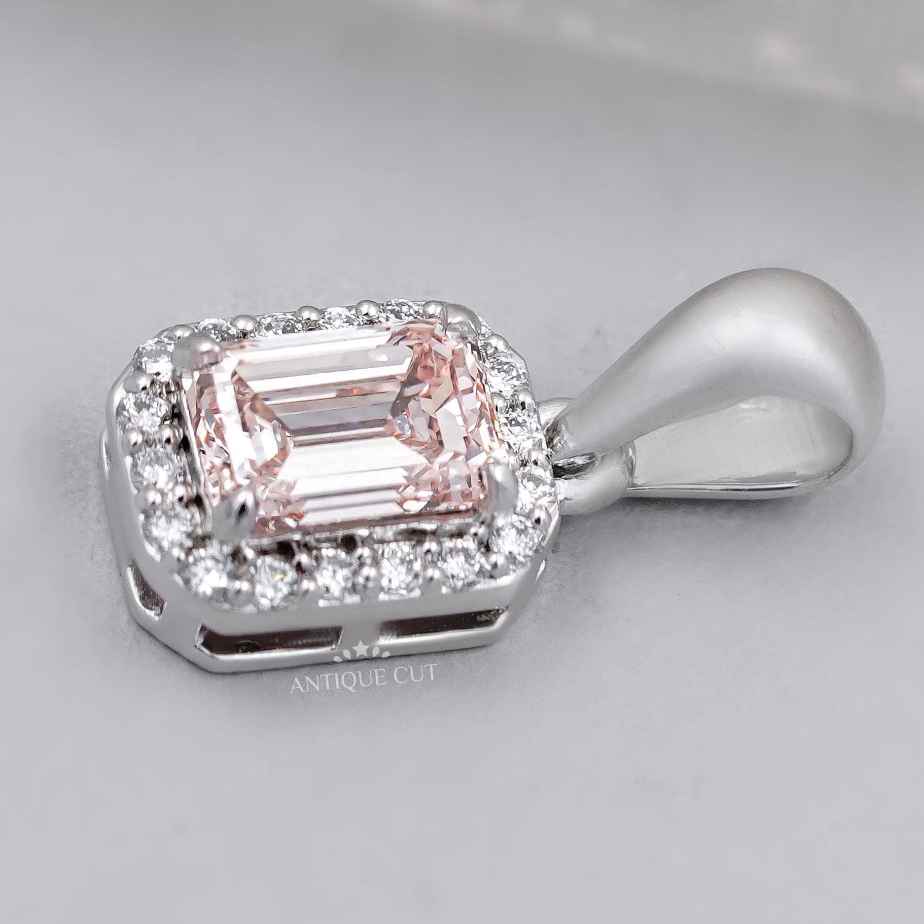 Close up of emerald cut halo diamond pendant