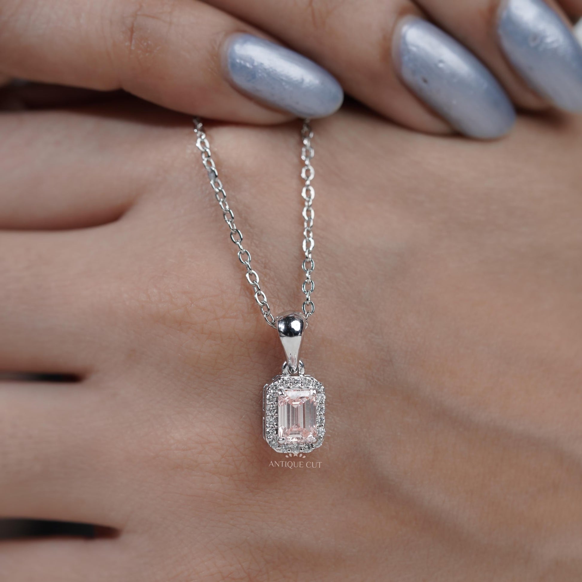 Modern emerald cut halo pendant white gold