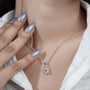 Emerald cut diamond pendant with halo setting