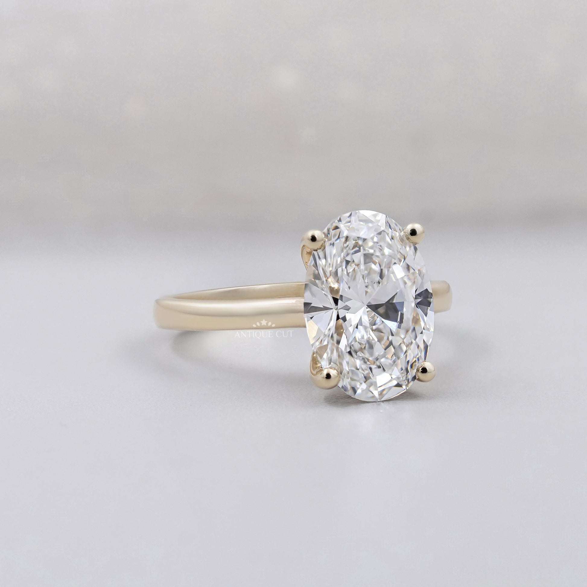 Oval cut solitaire diamond engagement ring in yellow gold