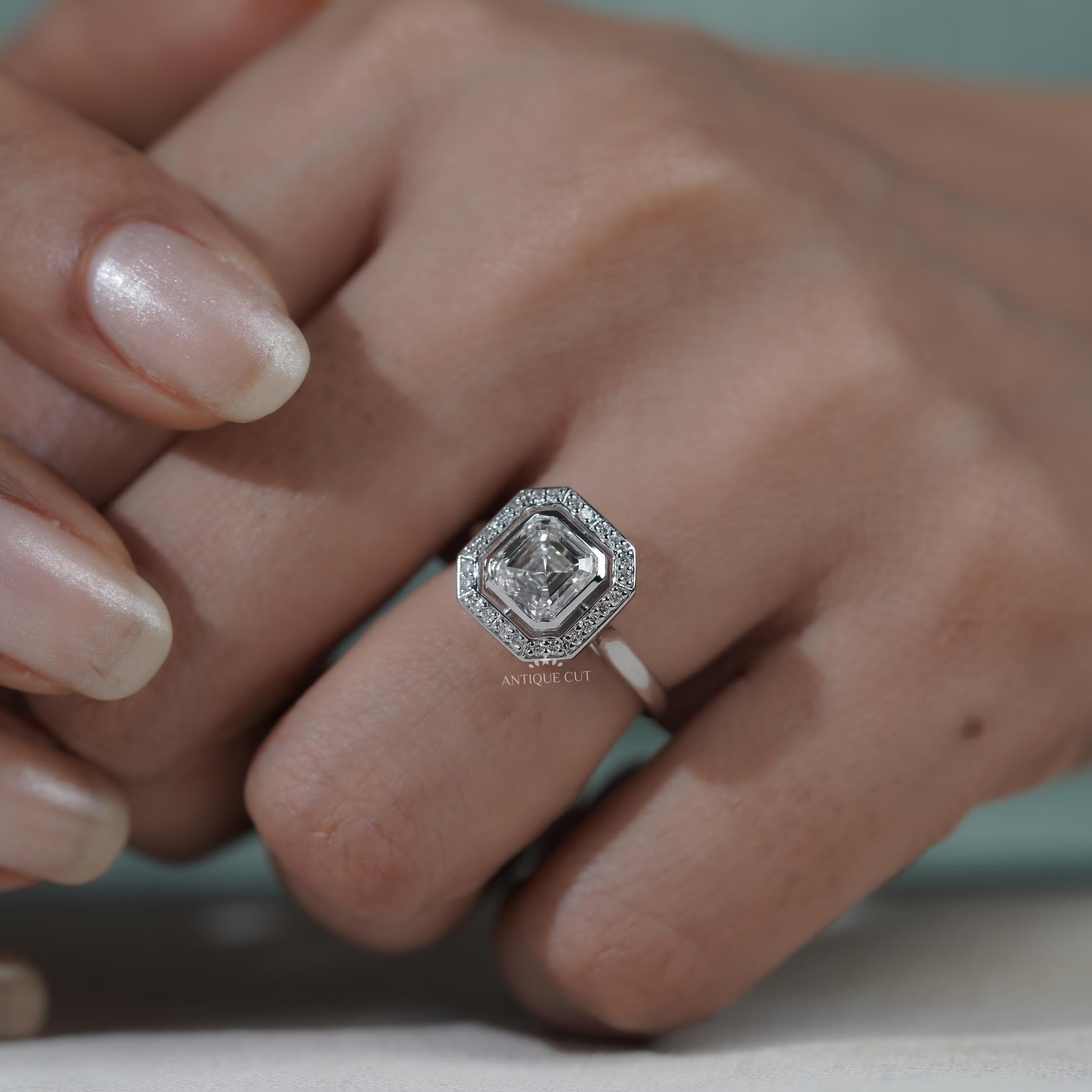 White gold Asscher diamond proposal ring with halo accents