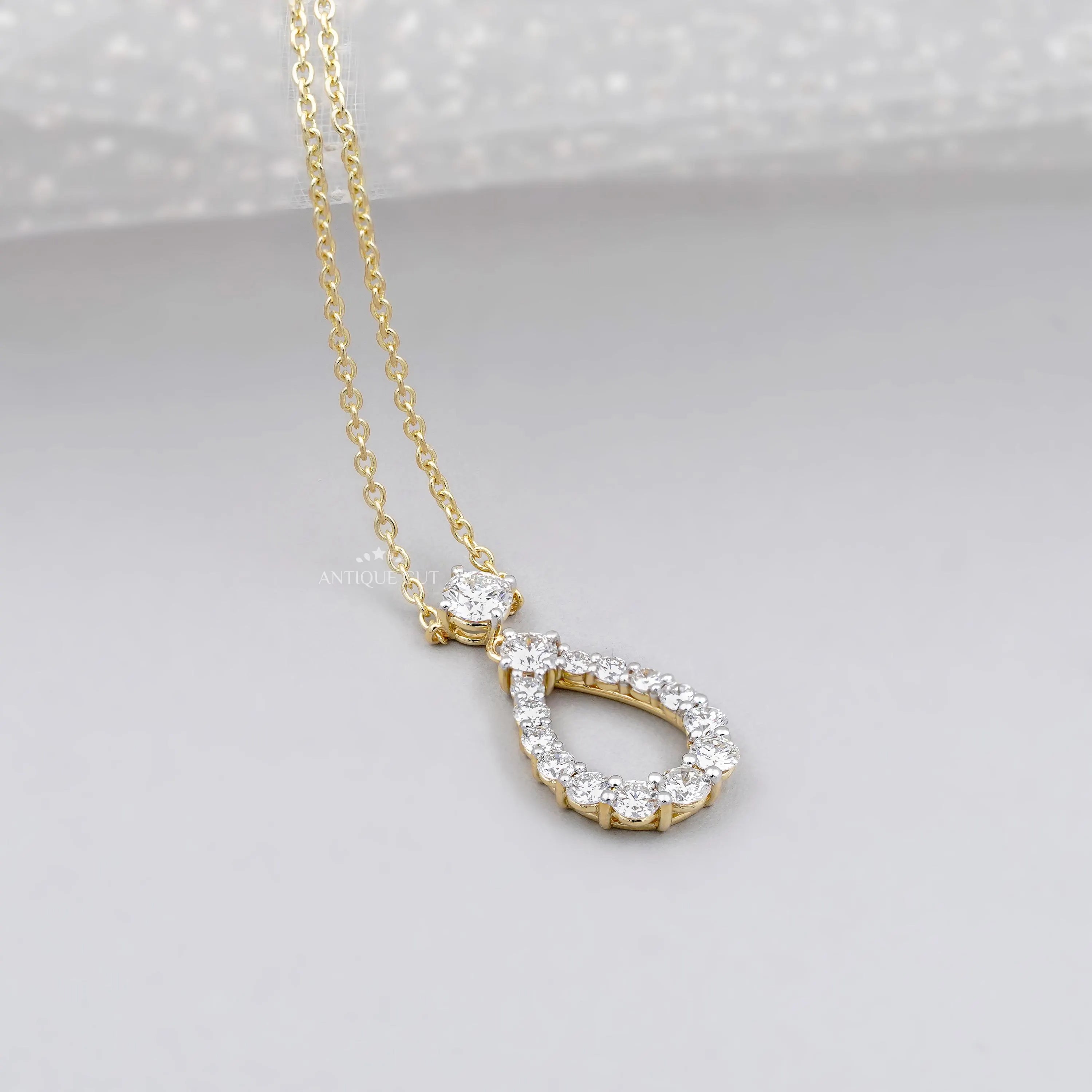 Yellow gold teardrop pendant necklace with diamonds