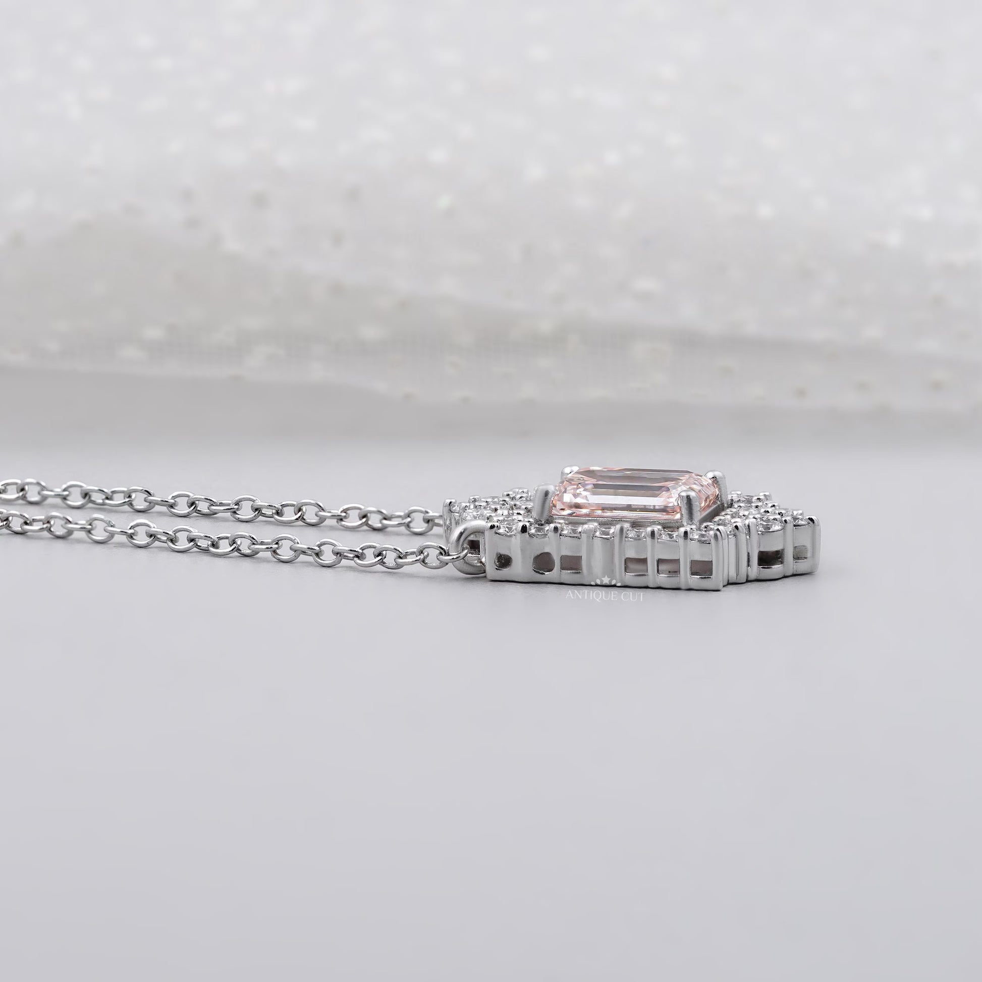 Elegant blush pink emerald pendant with round diamonds