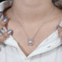 White gold pendant with emerald and diamond halo