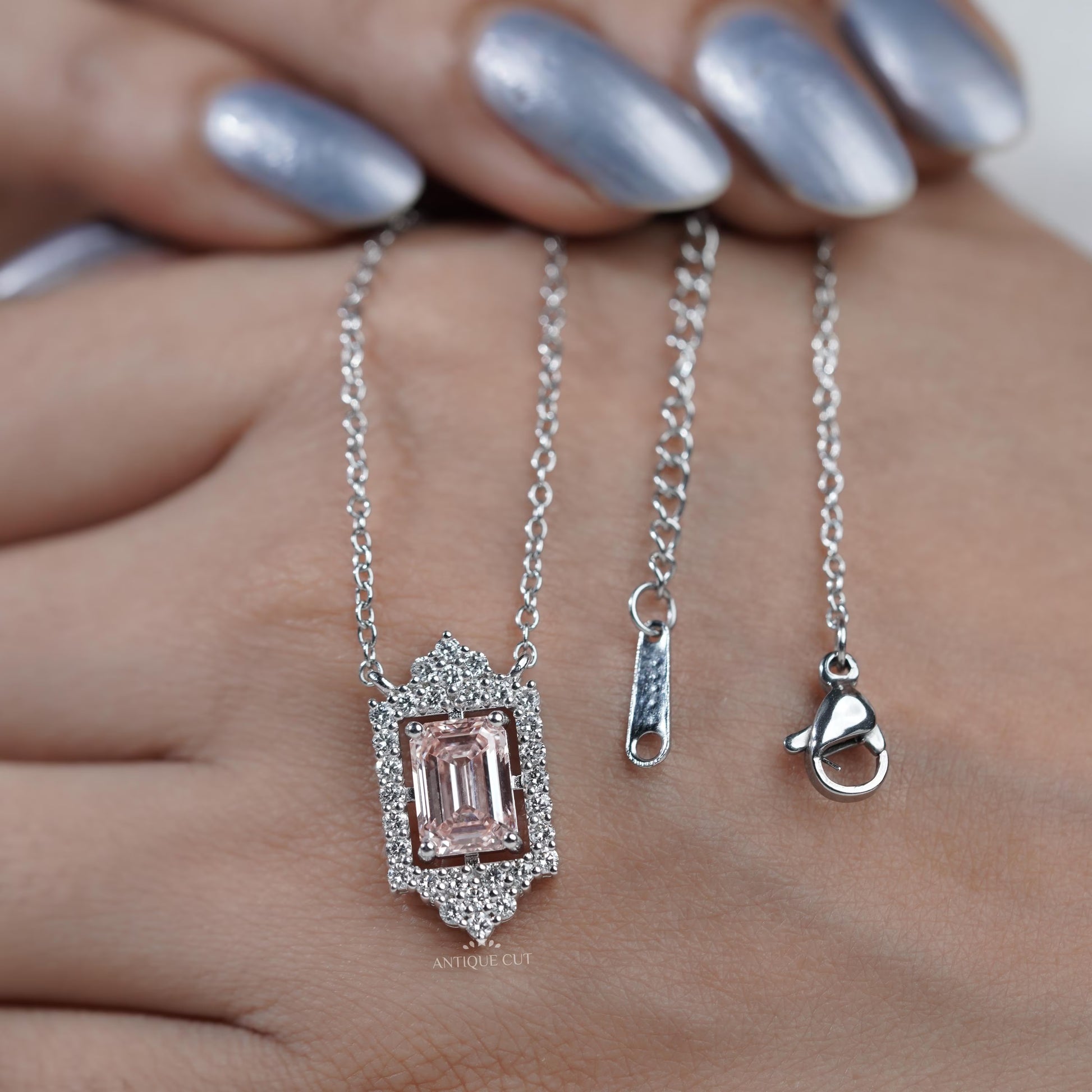 Round diamond halo pendant with blush pink emerald center
