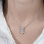 Modern round diamond halo pendant with emerald