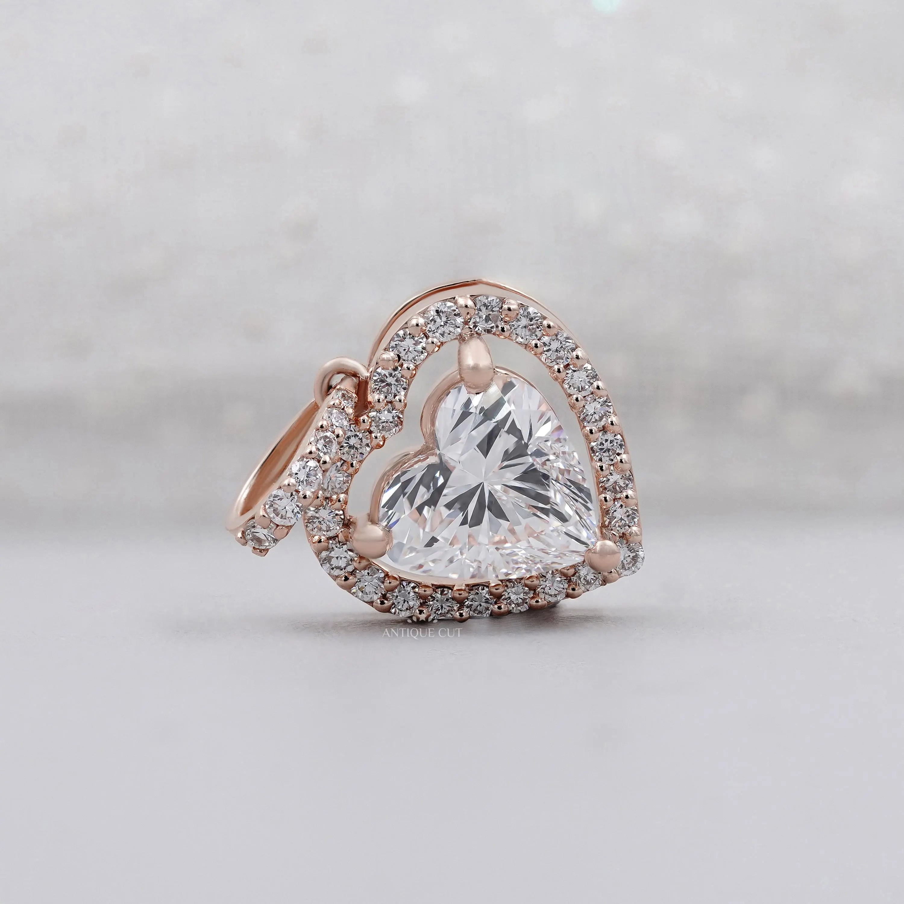 Rose gold heart-shaped diamond pendant with halo