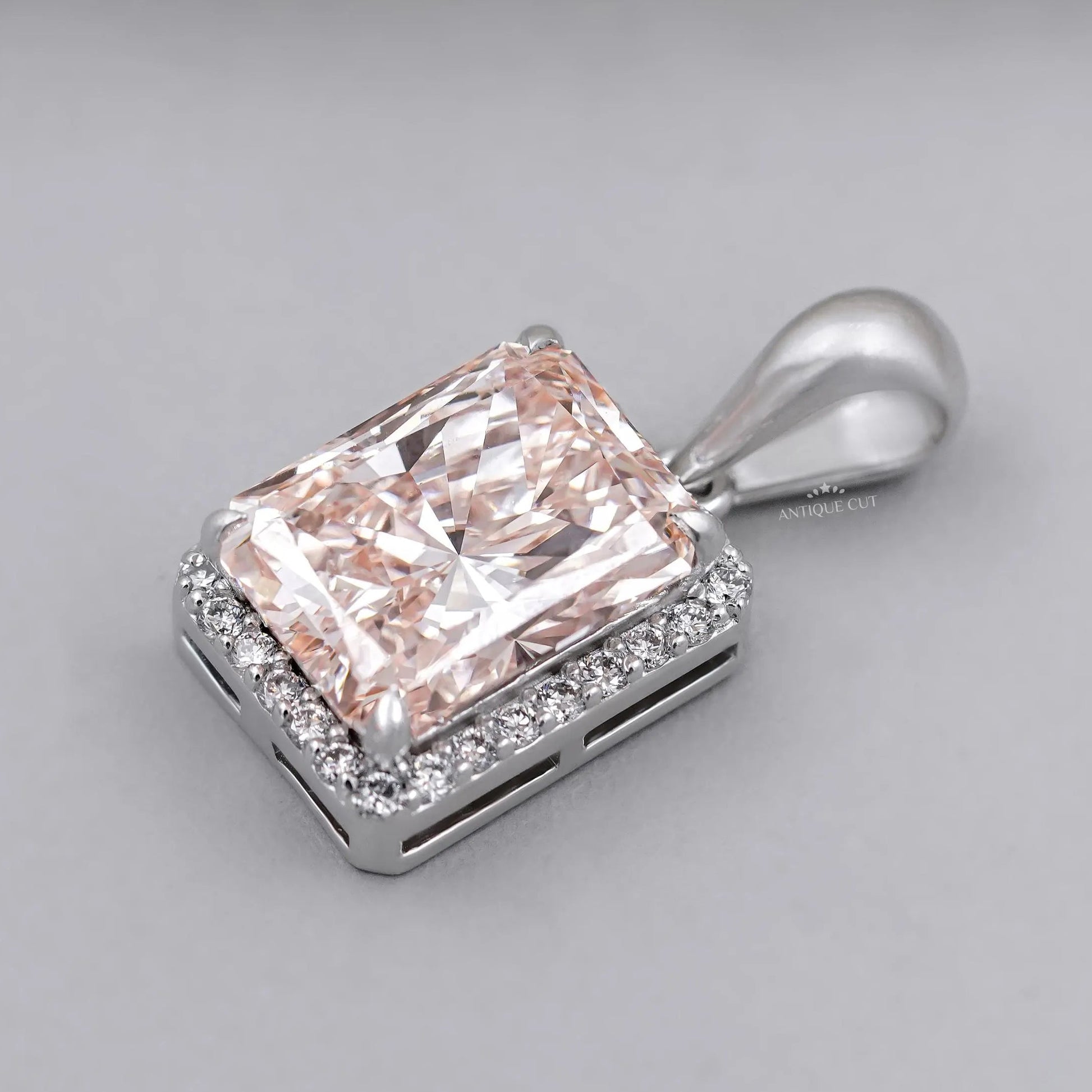 Fancy pink radiant diamond pendant with halo setting